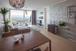 a living room with a couch and a table at Opatija Deluxe Apartment with swimming pool in Opatija