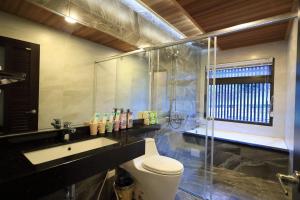 a bathroom with a toilet and a sink and a shower at 花蓮漫漫時光電梯包棟民宿 in Hualien City +37 photos