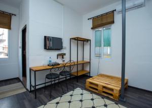 a room with a desk and a table and a bench at Yakety Yak Hostel in Kathmandu