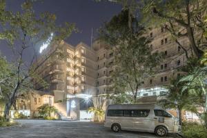 a van parked in front of a building at night at Carnation Residence in Samut Prakan