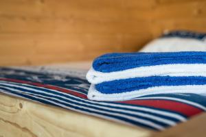 a stack of towels sitting on top of a bed at Waterlodge in Wilhelminadorp