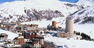 a city in the snow in front of a mountain at Casa Glesia in Sestriere