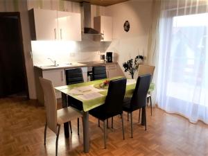 a kitchen and dining room with a table and chairs at Ferienwohnung Bender in Sinsheim