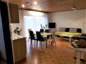 a kitchen and a living room with a table and a bed at Ferienwohnung Bender in Sinsheim