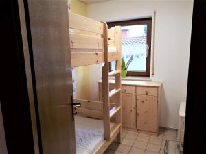 a bunk bed in a room with a window at Ferienwohnung Bender in Sinsheim