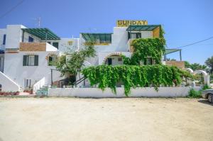 a house with ivy growing up the side of it at Sunday Studios in Agia Anna Naxos