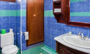 a blue tiled bathroom with a toilet and a sink at DAR DIAF CHERAGA in Alger