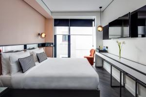 a bedroom with a large white bed and a desk at The Westist Hotel & Spa - Special Category in Istanbul