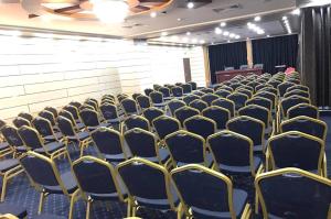 an empty room with chairs and a podium at EL BEY in Constantine