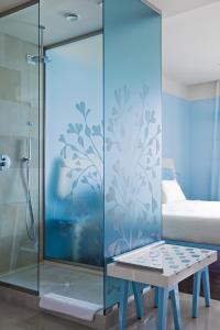 a shower stall with a bench in a bedroom at JR Hotels Bari Grande Albergo delle Nazioni in Bari