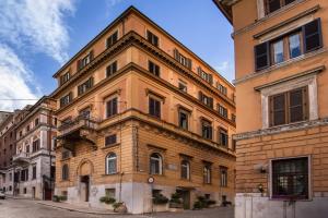 un grand bâtiment en briques sur le côté d'une rue dans l'établissement Al Manthia Hotel - Gruppo Trevi Hotels, à Rome
