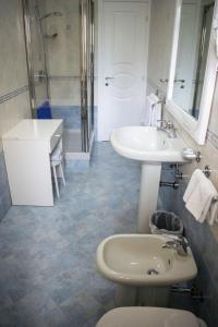 a bathroom with a sink and a toilet and a mirror at La casa D'a...mare in Maiori