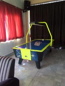 uma mesa de pingue-pongue azul e amarelo num quarto em Palace Hotel em Bsharri