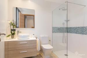 a bathroom with a toilet and a glass shower at Ca Na Foc in Sa Pobla +17 photos