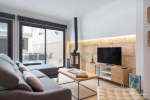 a living room with a couch and a tv at Ca Na Foc in Sa Pobla