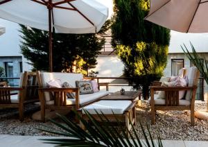 a patio with chairs and a table and an umbrella at New Line Village Apartments in Sunny Beach