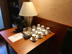 a table topped with a lamp and a vase on top of it at Pension Madara in Vienna