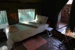 a bedroom with a bed in a tent at Epupa Camp in Epupa