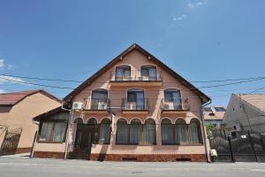 a large building with balconies on a street at Kon Tiki in Sibiu
