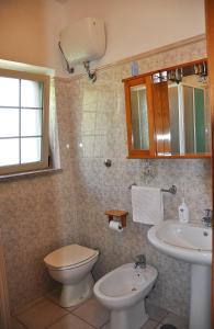 a bathroom with a toilet and a sink at Casa Vacanze Marcella in Palinuro