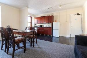 a kitchen with a table and chairs and a refrigerator at The Bridge Inn in Tillicoultry