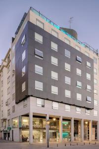 a large gray building with a lot of windows at Sea You Hotel Port Valencia in Valencia