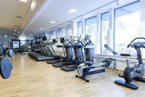 a gym with a row of treadmills and machines at Part-Time Home Rotebro in Rotebro
