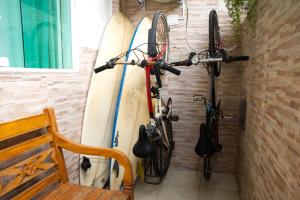 a bike is leaning against a wall with surfboards at Pousada Barra da Tijuca in Rio de Janeiro