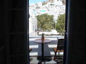 a room with a table and a view of a city at Armonia Pension in Ios Chora