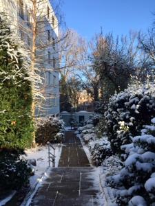 a snow covered path in front of a building at Apartment Centrum im Grünen in Nuremberg +7 photos