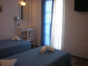Ένα ή περισσότερα κρεβάτια σε δωμάτιο στο Armonia Pension