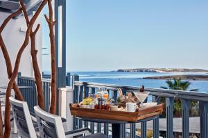 a tray of food on a table on a balcony at Parian Boutique Hotel in Naousa