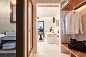 a room with a bedroom and a living room at Parian Boutique Hotel in Naousa