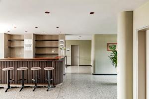 a lobby with a bar and stools at Banja Kulaši in Kulaši