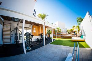 an outdoor workout room with exercise equipment on a house at Vanilla Garden Boutique Hotel - Adults Only in Playa de las Americas