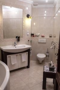 a bathroom with a sink and a toilet at Penzion Rosenthal in Ružindol