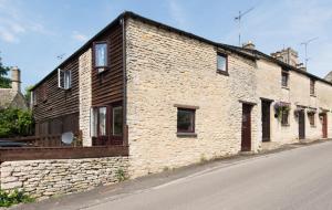 a brick building on the side of a street at Mill View in Northleach