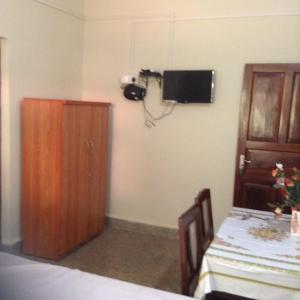 a room with a table and a camera on the wall at J & B Holiday Homes in Benaulim
