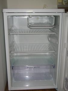 an empty refrigerator with its door open in a kitchen at Apartman pod Dedovkou in Oščadnica