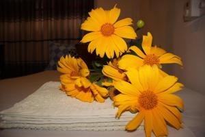 a bunch of yellow flowers in a vase on a table at Miheen Hotel & Resort - Anuradhapura in Mihintale