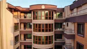 a tall building with a clock on top of it at Апартаменти "Лазур" в сърцето на Поморие in Pomorie