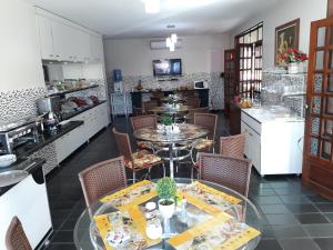 a dining room with a table and chairs in a kitchen at Viana Palace Hotel in Juazeiro do Norte