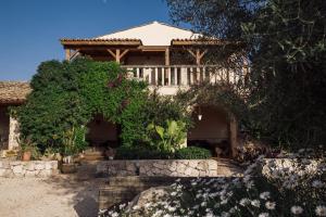 a house with trees and flowers in front of it at Casa di Melo - Organic Country Hotel in Cassibile