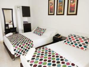 Ένα ή περισσότερα κρεβάτια σε δωμάτιο στο Hotel Cosmos Sincelejo