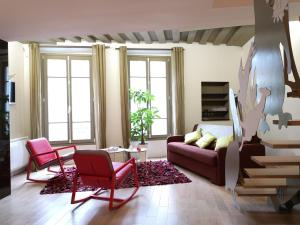 sala de estar con sofá y 2 sillas en Beautiful duplex in the center of Paris, en París