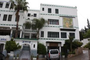 a white building with a van parked in front of it at DAR DIAF CHERAGA in Alger
