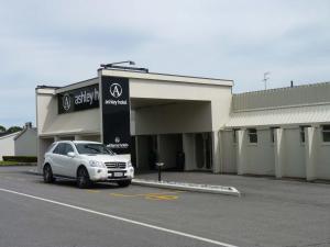 a white car parked in front of a building at The Ashley Hotel Greymouth in Greymouth