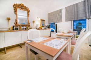 a dining room with two tables and a mirror at Maris Vama Veche in Vama Veche