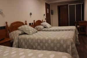 Postel nebo postele na pokoji v ubytování Hostal Extremeño