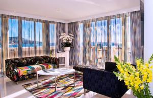 a living room with a couch and a table at Hôtel West End Promenade in Nice